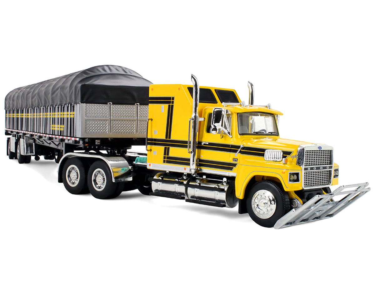 Ford LTL 9000 with 60" Aerodyne Sleeper and 53' Wilson Roadbrute Flatbed Trailer with Covered Wagon Yellow with Black Stripes 1/64 Diecast Model