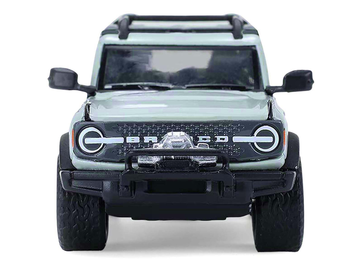 2021 Ford Bronco 4-Door Badlands Cactus Gray with Black Top and Motorcycle with Utility Trailer "Hitch & Tow" Series 33 1/64 Diecast Model Cars