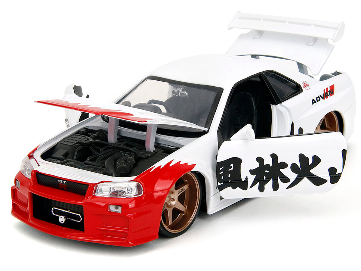 2002 Nissan Skyline GT-R (R34) RHD (Right Hand Drive) White with Red Graphics and Ryu Diecast Figure "Street Fighter" Video Game "Anime Hollywood Rides" Series 1/24 Diecast Model Car