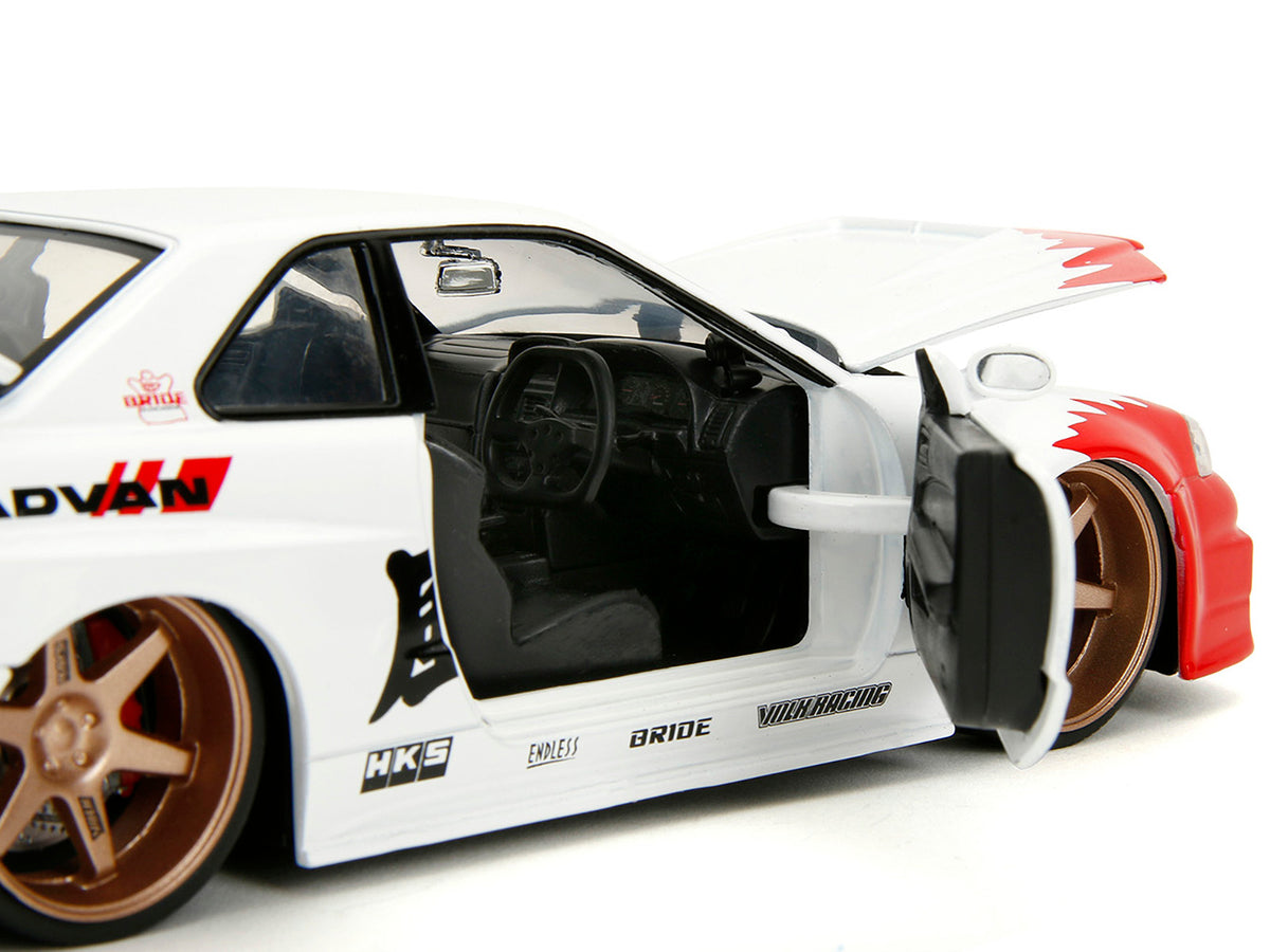 2002 Nissan Skyline GT-R (R34) RHD (Right Hand Drive) White with Red Graphics and Ryu Diecast Figure "Street Fighter" Video Game "Anime Hollywood Rides" Series 1/24 Diecast Model Car