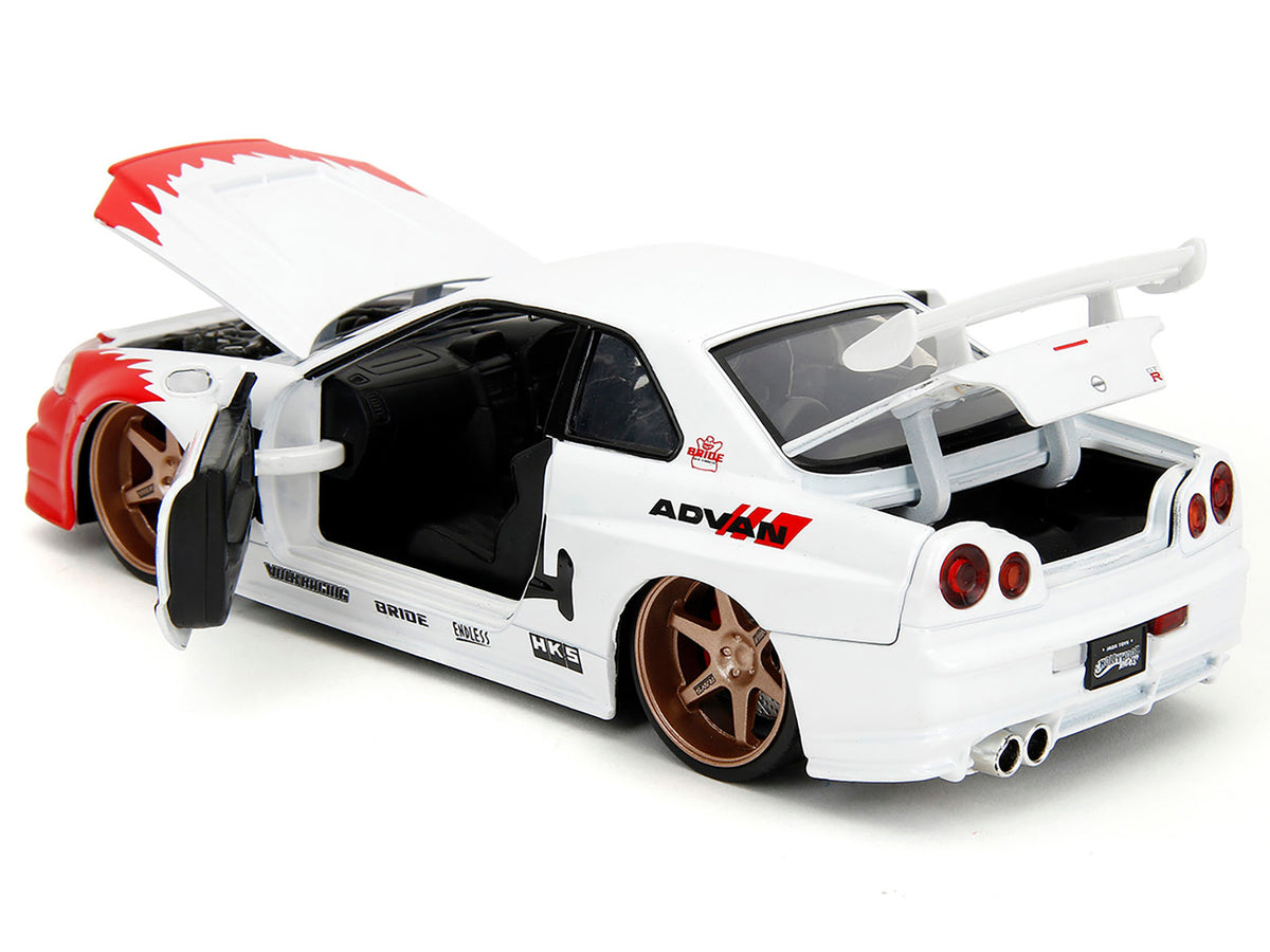 2002 Nissan Skyline GT-R (R34) RHD (Right Hand Drive) White with Red Graphics and Ryu Diecast Figure "Street Fighter" Video Game "Anime Hollywood Rides" Series 1/24 Diecast Model Car