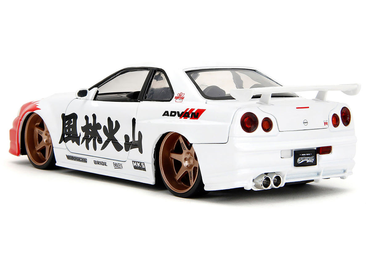 2002 Nissan Skyline GT-R (R34) RHD (Right Hand Drive) White with Red Graphics and Ryu Diecast Figure "Street Fighter" Video Game "Anime Hollywood Rides" Series 1/24 Diecast Model Car