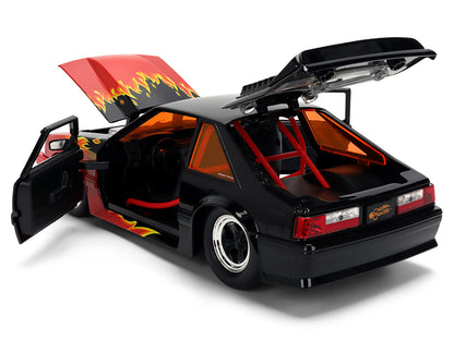 1989 Ford Mustang GT Black with Red Flame Graphics and Chester Cheetah Diecast Figure "Cheetos Flamin' Hot" "Hollywood Rides" Series 1/24 Diecast Model Car