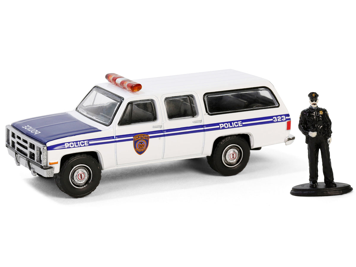 1985 GMC Suburban 2500 "New York City Transit Police Department" White with Blue Stripes and Police Officer Figure "The Hobby Shop" Series 16 1/64 Diecast Model Car