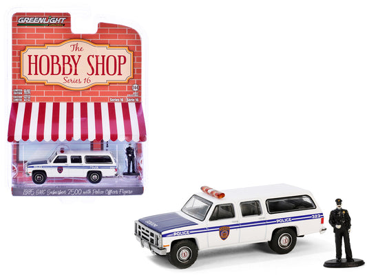 1985 GMC Suburban 2500 "New York City Transit Police Department" White with Blue Stripes and Police Officer Figure "The Hobby Shop" Series 16 1/64 Diecast Model Car