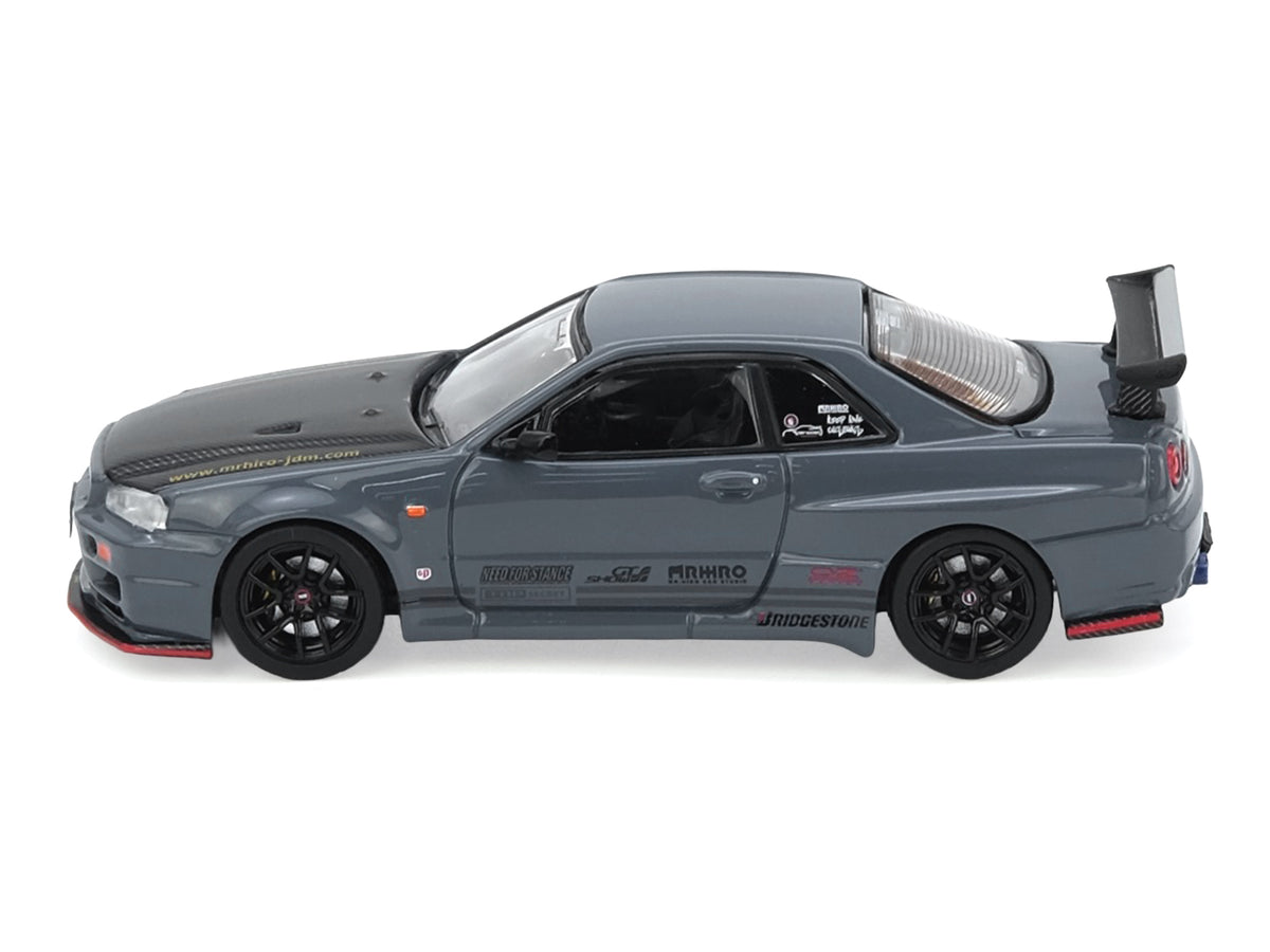 Nissan Skyline GT-R (R34) "Top Secret" RHD (Right Hand Drive) Stealth Gray with Carbon Hood "GTSHOW 2025 Event Edition" 1/64 Diecast Model Car