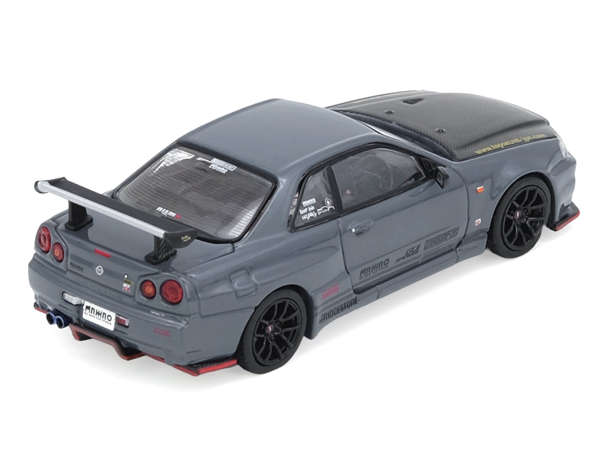 Nissan Skyline GT-R (R34) "Top Secret" RHD (Right Hand Drive) Stealth Gray with Carbon Hood "GTSHOW 2025 Event Edition" 1/64 Diecast Model Car