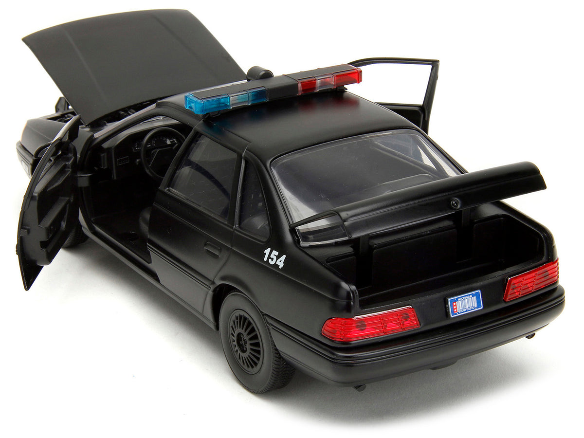 Ford Taurus OCP Matt Black "Detroit Police" and Robocop Diecast Figure 35th Anniversary "Robocop" (1987) Movie "Hollywood Rides" Series 1/24 Diecast Model Car