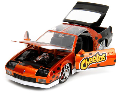 1985 Chevrolet Camaro Z/28 Orange Metallic with Graphics and Chester Cheetah Diecast Figure "Cheetos" "Hollywood Rides" Series 1/24 Diecast Model Car