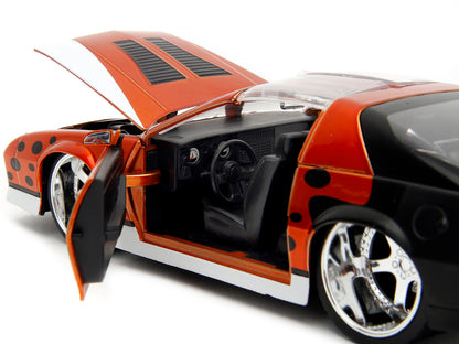 1985 Chevrolet Camaro Z/28 Orange Metallic with Graphics and Chester Cheetah Diecast Figure "Cheetos" "Hollywood Rides" Series 1/24 Diecast Model Car