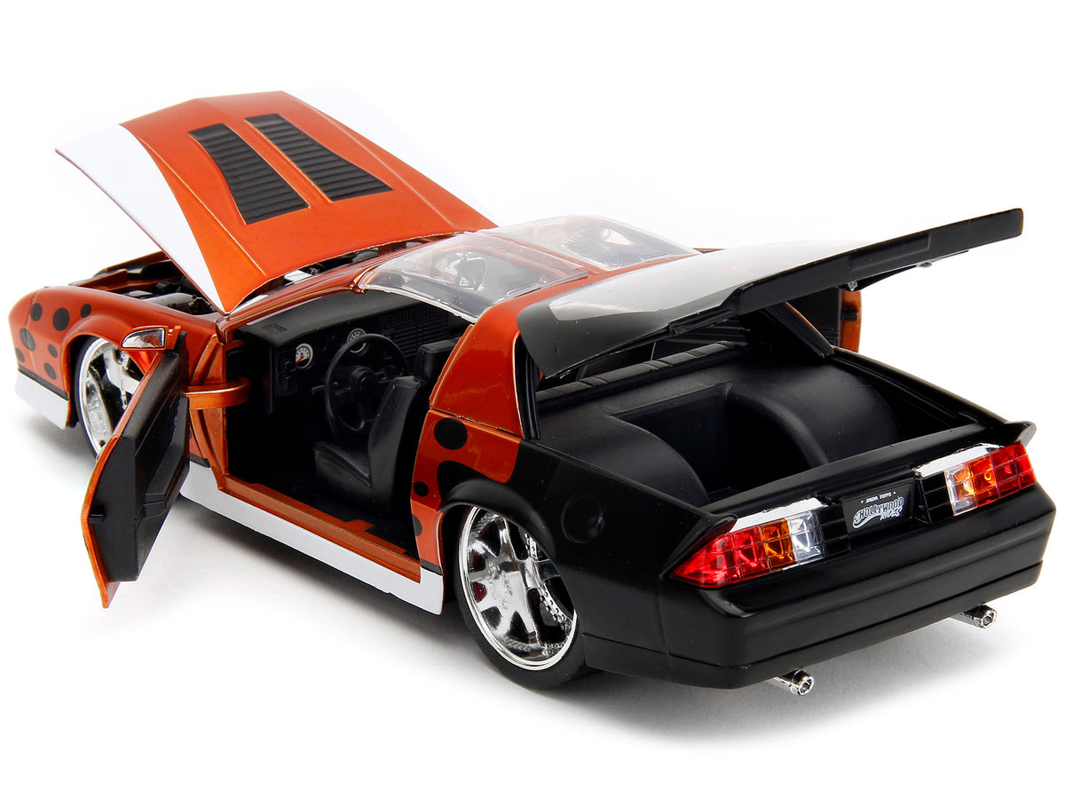 1985 Chevrolet Camaro Z/28 Orange Metallic with Graphics and Chester Cheetah Diecast Figure "Cheetos" "Hollywood Rides" Series 1/24 Diecast Model Car